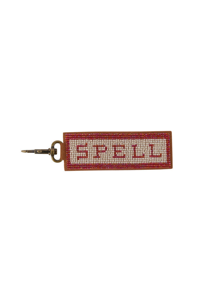 Spell Beaded Key Ring in Pink with cream and red seed bead logo on tan leather backing