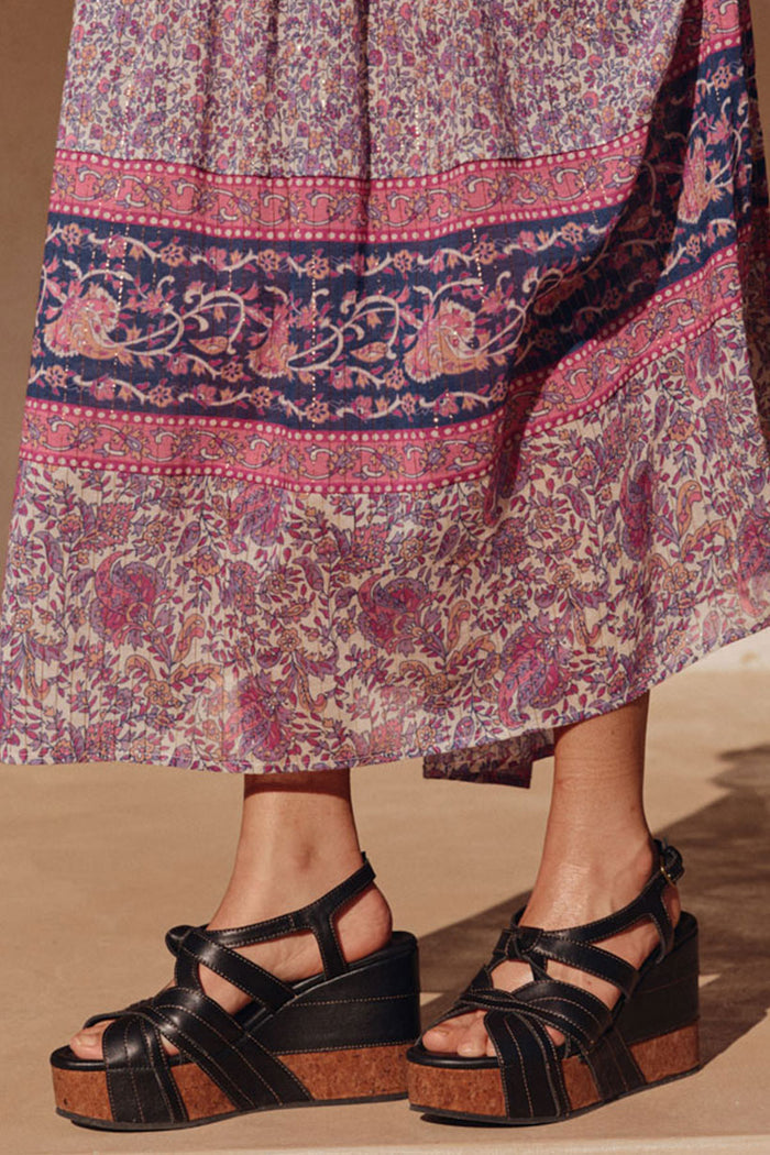 Close-up of Starlet Wedge in Onyx with cork sole, leather straps, contrast topstitching, styled with floral maxi skirt