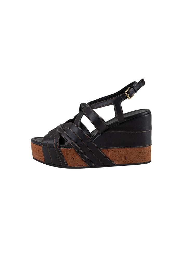 Side view of Starlet Wedge in Onyx showing cork veneer sole, contrast topstitching, and gold buckle ankle strap