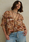 Rose Quartz floral blouse flat lay showing front ties, neck ruffle, lace trim, and shaped hem detail