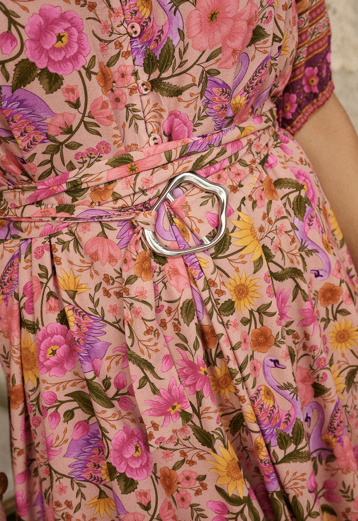 Close-up of silver wavy buckle on printed viscose tie belt, lilac rose floral print with button placket detail