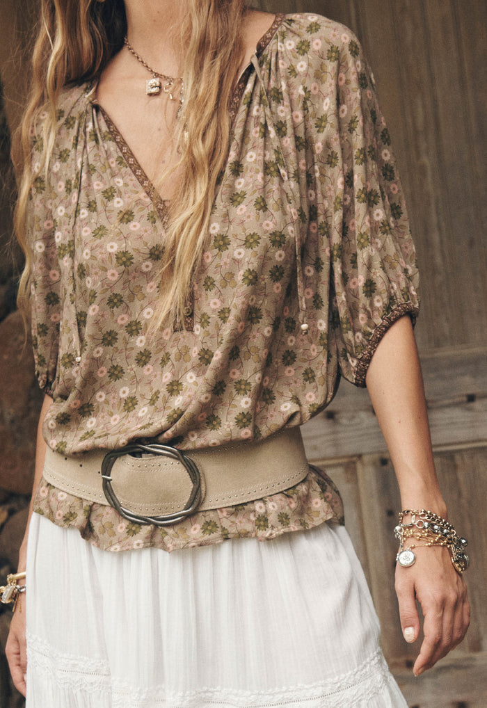 Model wearing Swan Lake blouse, front view showing contrast print border trim on neck and elastic sleeve hem