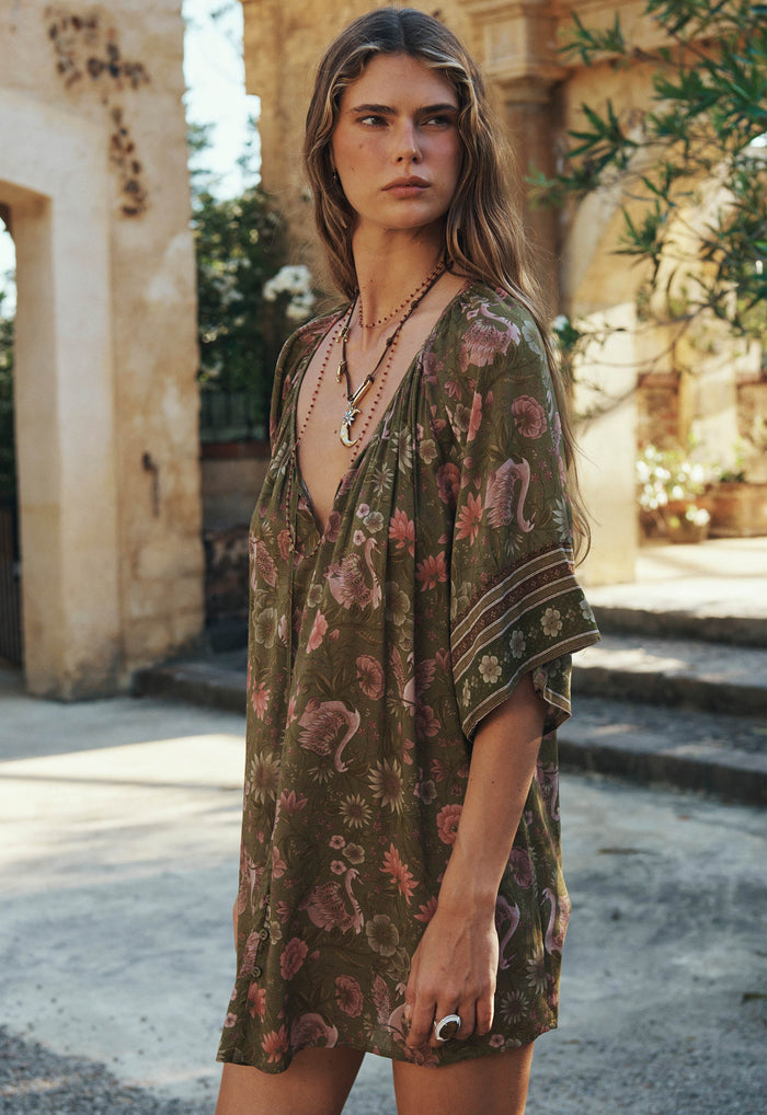 Three-quarter front view of Swan Lake Tunic Dress in Sage, showing V-neck, button-through front and border-print sleeve cuffs