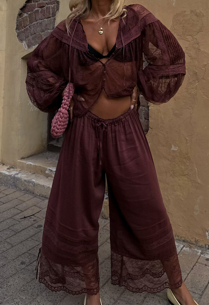 Front view of a model wearing Teodora Lace Pantaloon in Fudge, showing elastic gathered waist with self ties