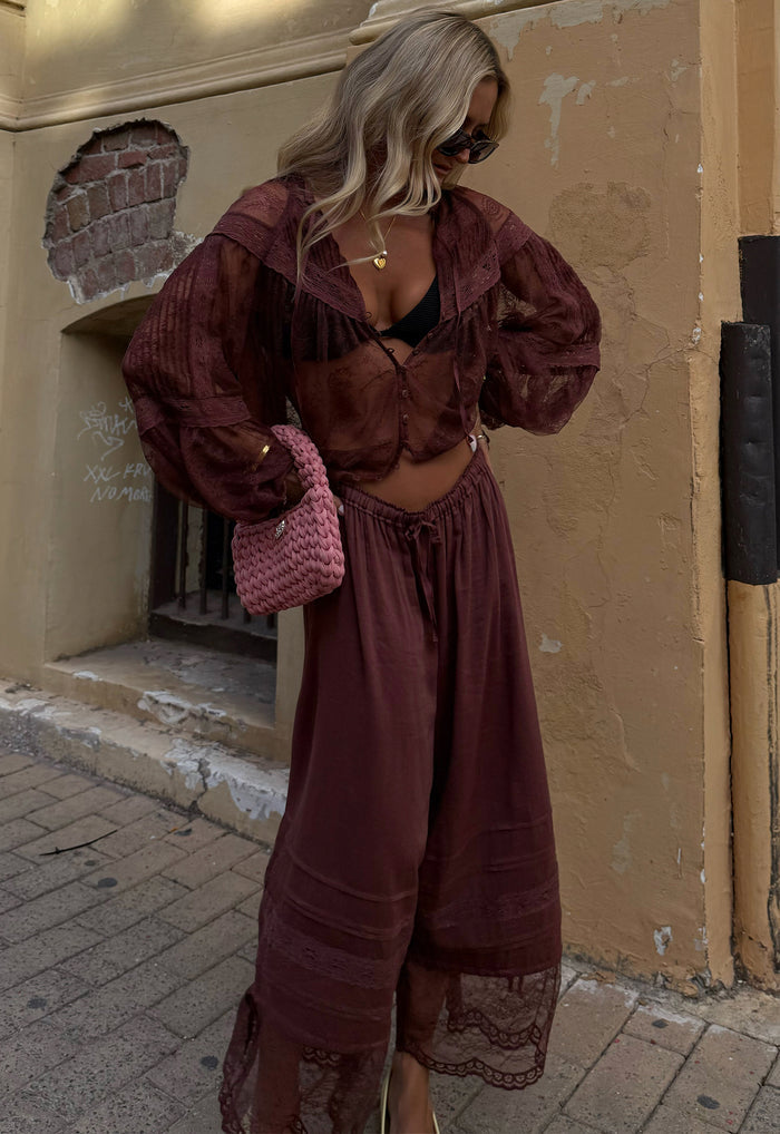 Model wearing fudge lace pantaloon with gathered elastic waist, pintucks, and lace hem, styled with matching top