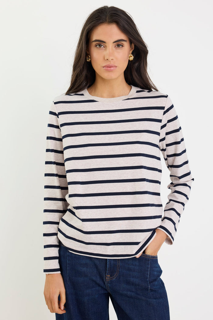 Woman wearing a striped sweater and jeans on a white background