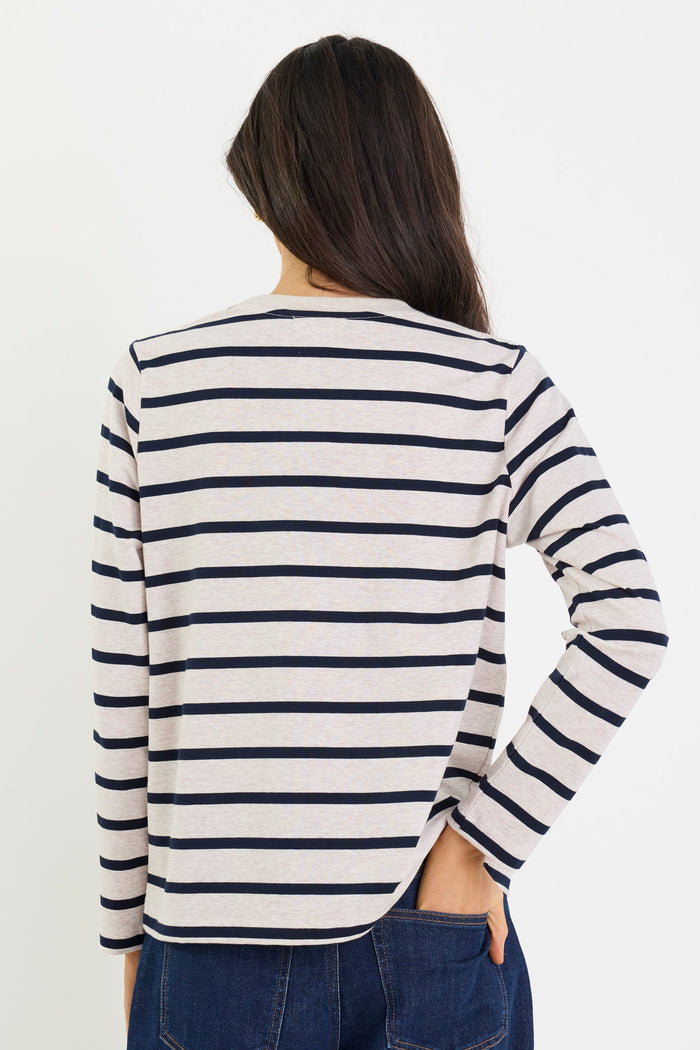Person wearing a striped long-sleeve shirt on a plain background