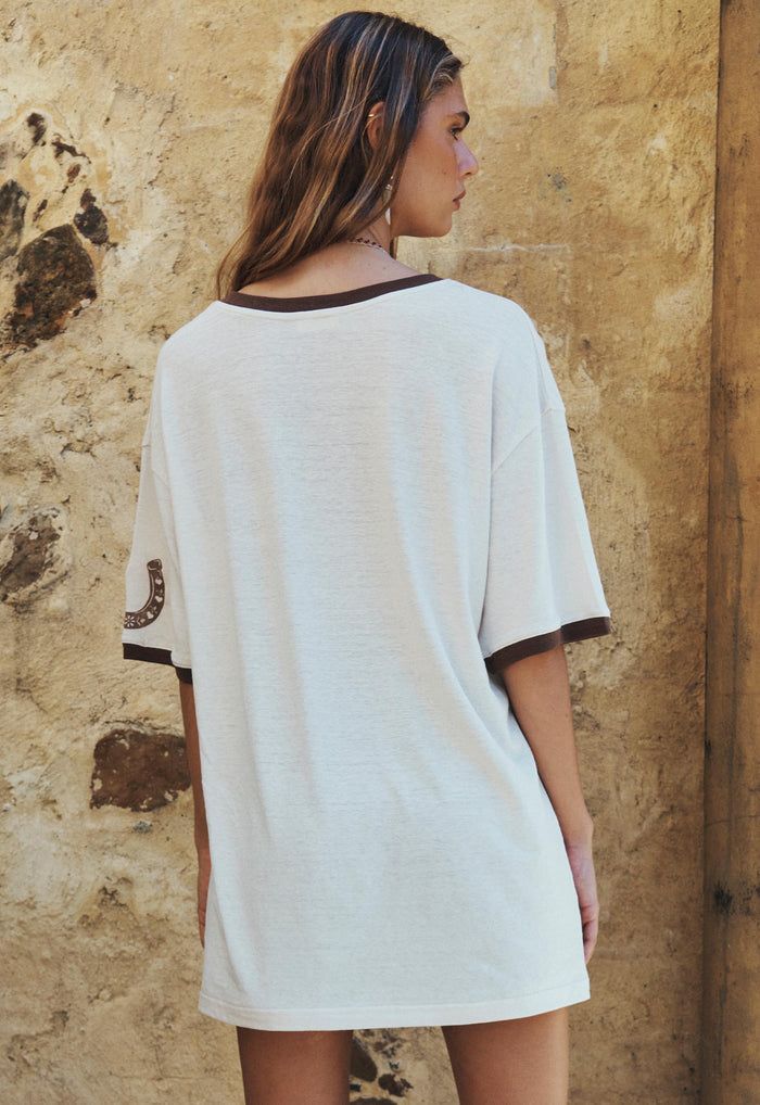 Back view of a model wearing Texas Sweetheart oversized tee, contrast brown neck and sleeve rib trim