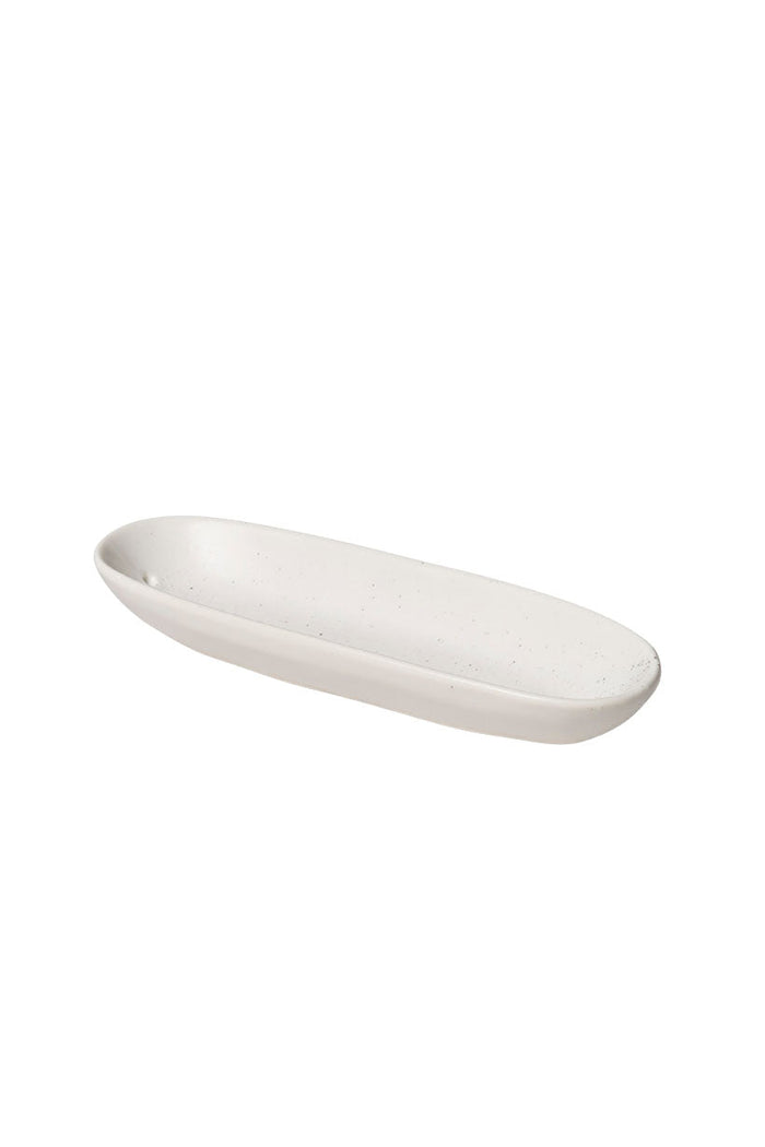 Angled view of oval white speckled ceramic incense holder with matte glaze finish