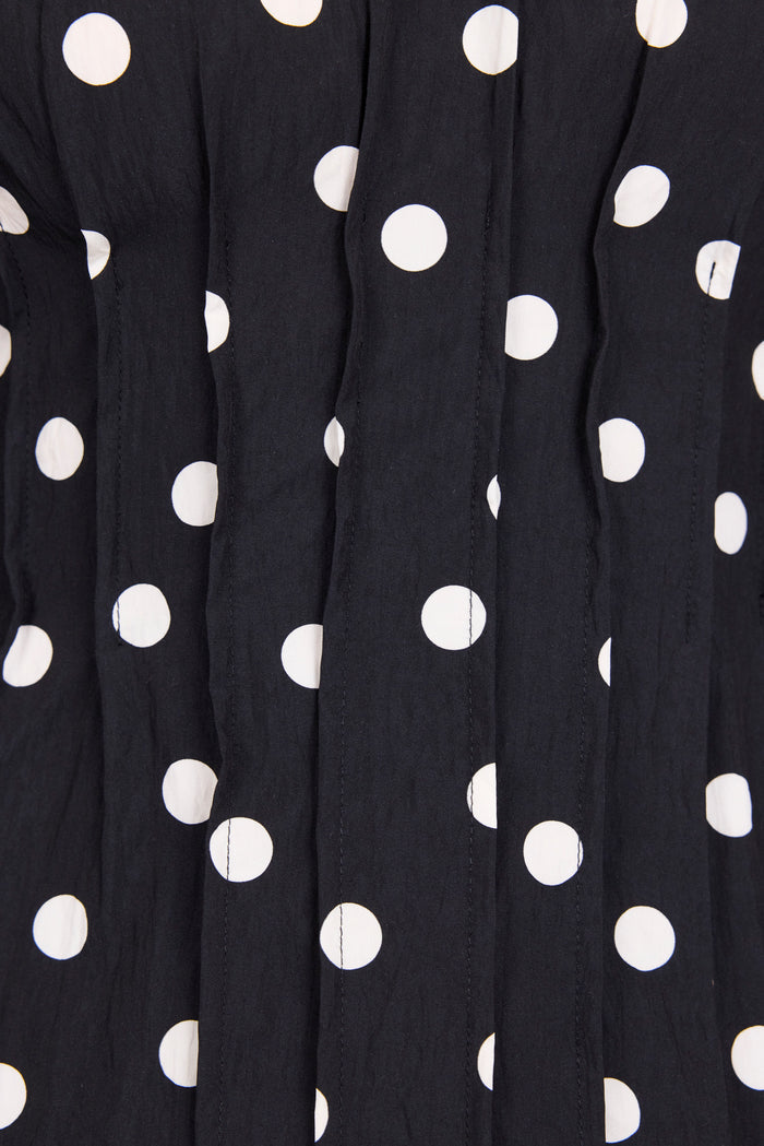 Close-up of black fabric with white polka dots