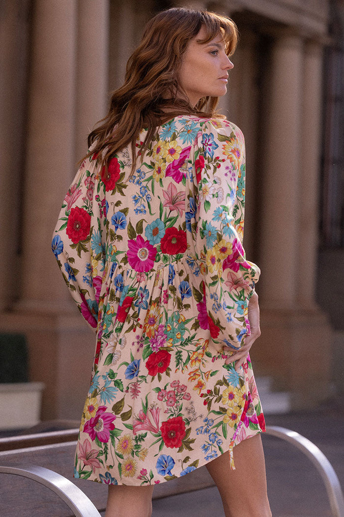Model wearing Valley of the Dolls Mini Dress in Opal, back view showing waist ties and wide cuffed sleeves