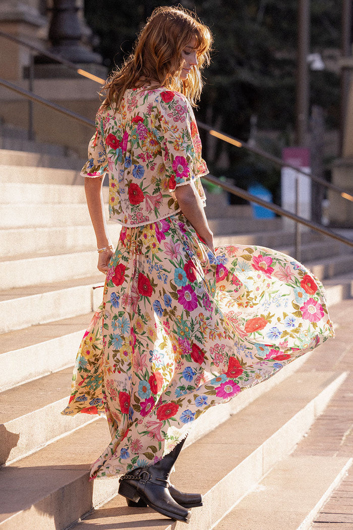 Back view of Valley of the Dolls Opal maxi skirt, floral TENCEL lyocell, hi-lo frayed hem, elastic waist with side ties