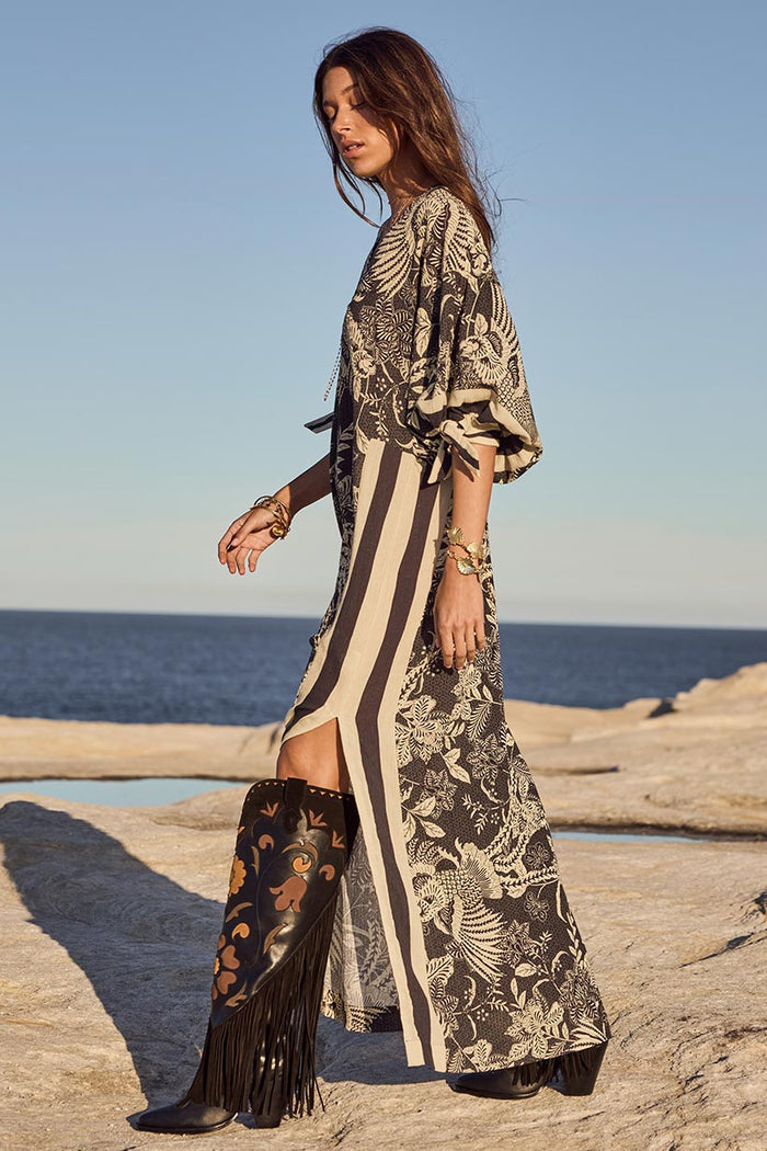 Side profile of a model in Volcano Goddess Kaftan, showing stripe detail, tie waist