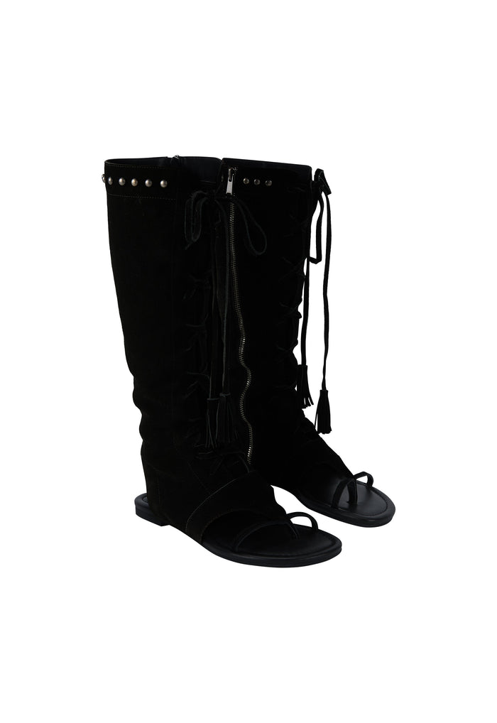 A pair of black knee-high boots with front lace-up detailing and small metallic studs near the top, shown against a plain white background.