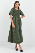 Woman wearing a green checkered dress on a white background