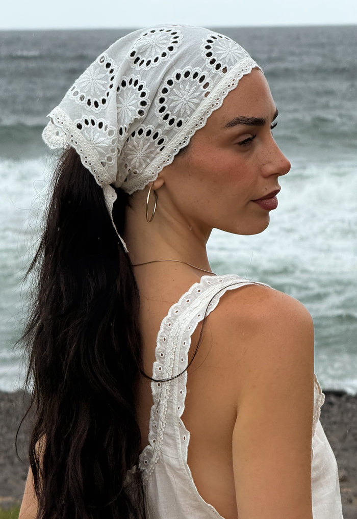 Spell Yaya Headscarf in Antique White organic cotton broderie anglaise with scallop trim, worn beachside