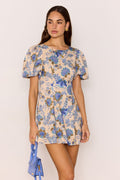 model wears a blue floral mini dress